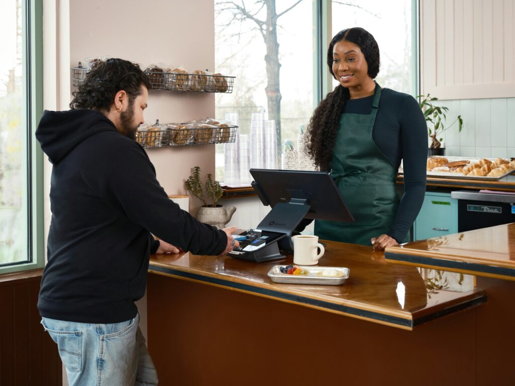 Small business owner serving a customer
