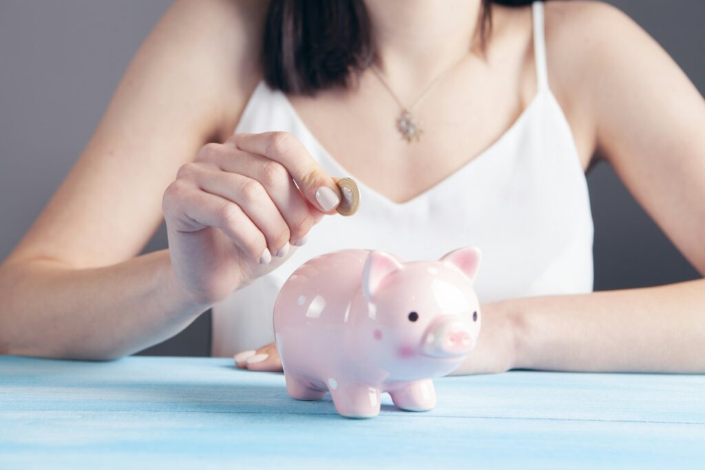 Saving coins in a piggy bank